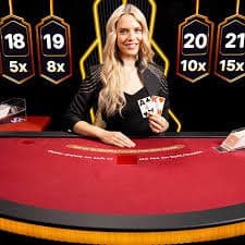 Multi-camera broadcast studio with professional dealers running live blackjack and roulette stations